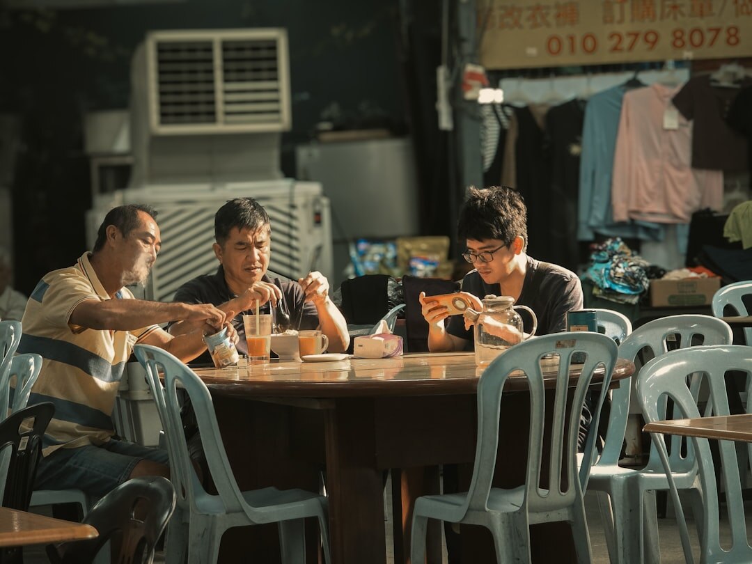 Three seniors enjoying a jigsaw puzzle together at a table