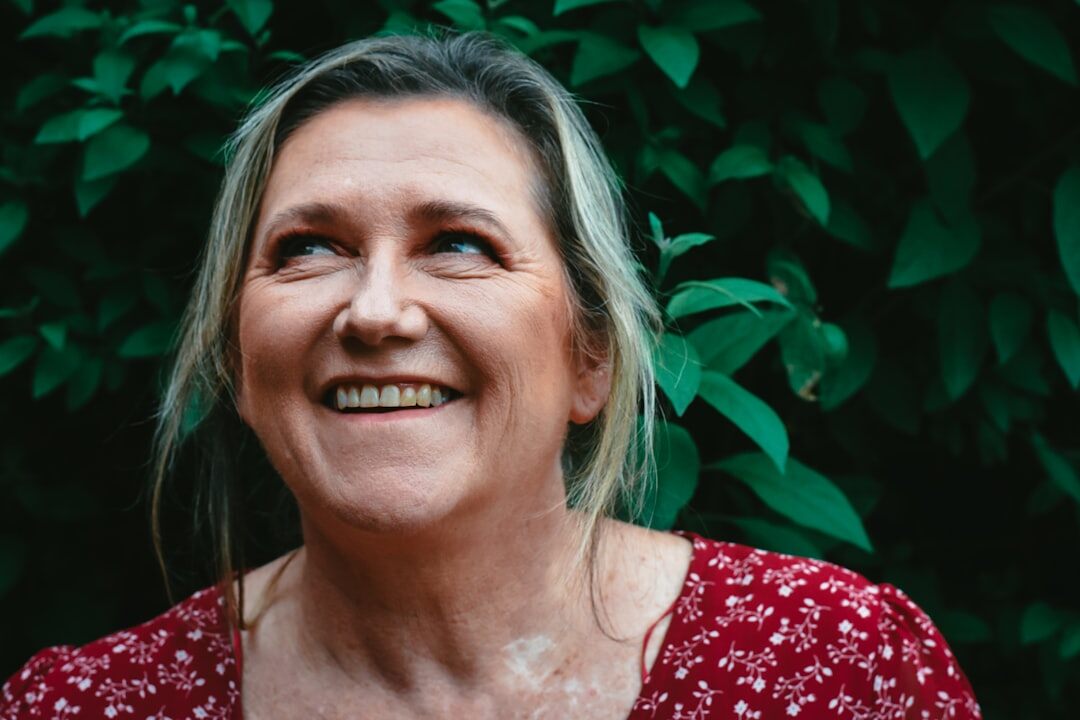 Portrait of a smiling older woman with grey hair and a floral dress