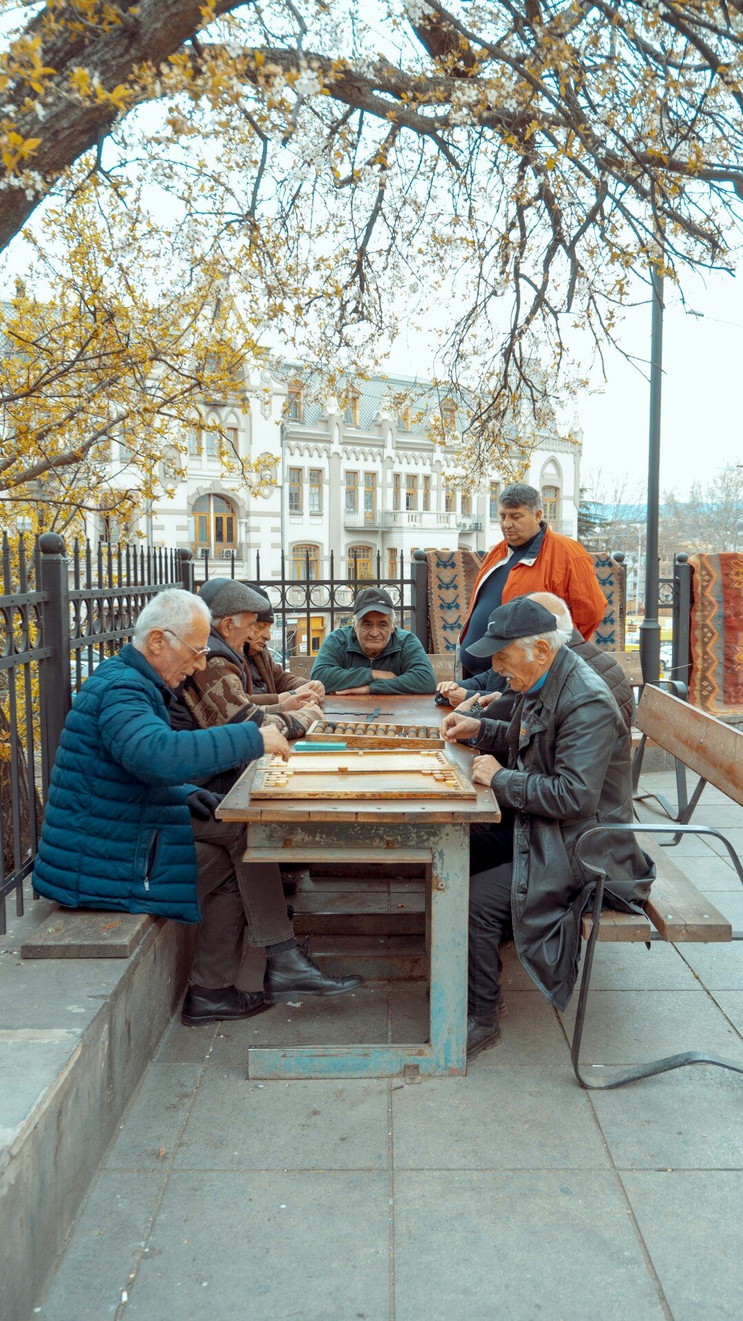 Group of seniors sitting around a table doing arts and crafts together